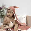Fabelab Clay Bunny Hooded Baby Towel. Modeled on child.