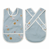 Fabelab Planetary Cross Back Bib Kid's Cotton Feeding Accessories. Front and back view, side by side. Light blue with white piping. Print of multicolored planets.