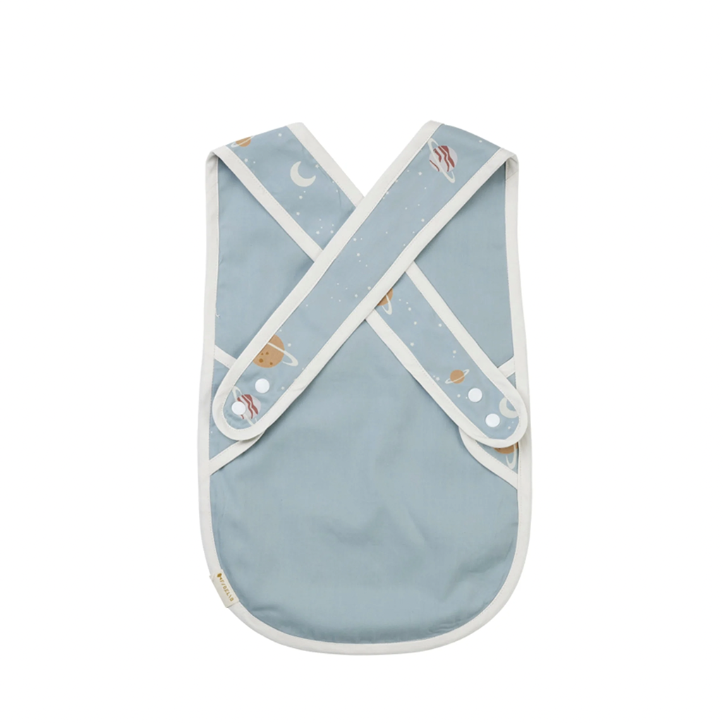 Front and Back View of Fabelab Planetary Cross Back Bib, Light Blue Cotton Baby Bib with White Piping and Planet Print