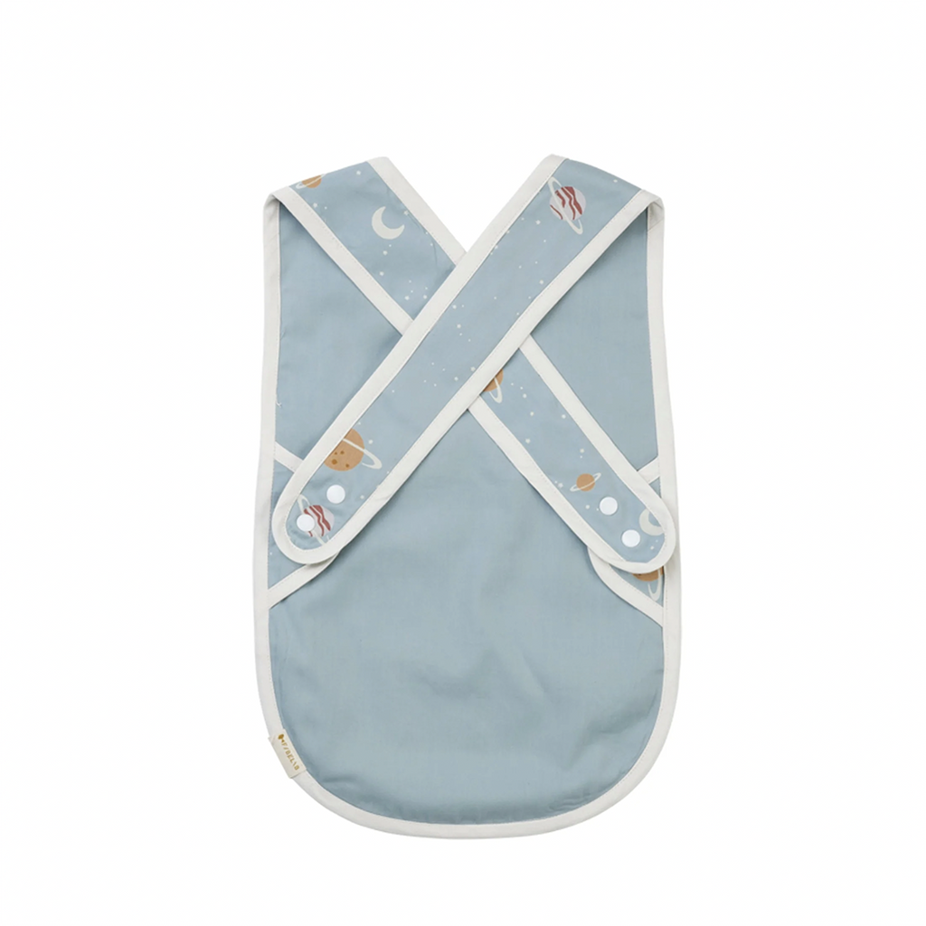 Fabelab Planetary Cross Back Bib Kid's Cotton Feeding Accessories. Back view. Light blue with white piping. Print of multicolored planets.