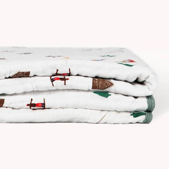 Ski away with the Little Unicorn Muslin Quilt in Powder Partry, a dreamy infant muslin blanket for little winter enthusiasts.