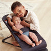 brother with baby in black grey baby bjorn bouncer seat