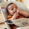 smiling baby in baby bjorn bouncer soft khaki beige