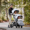 Woman pushing kids in Uppababy double stroller with CozyGanoosh Footmuff