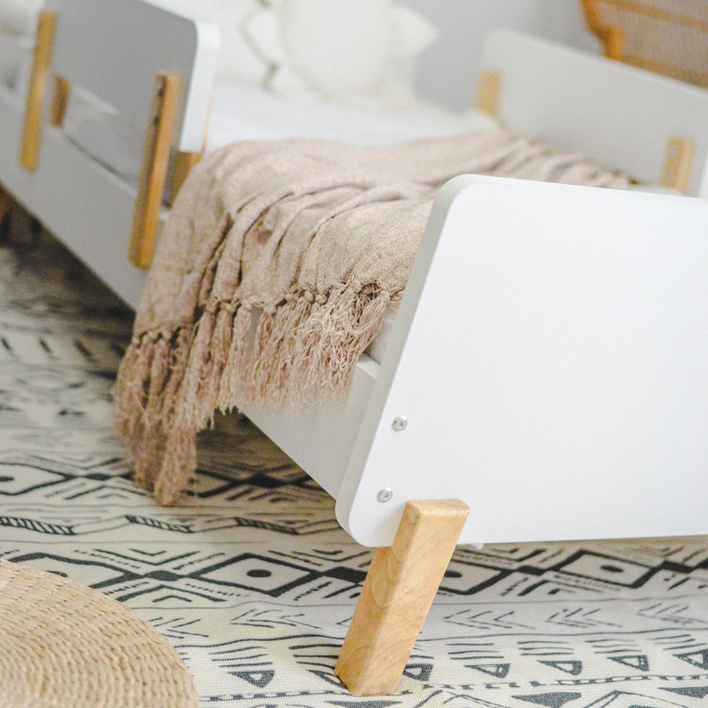 Dadada Muse Toddler Bed in White/Natural. Close up of hardware and legs.best toddler furniture