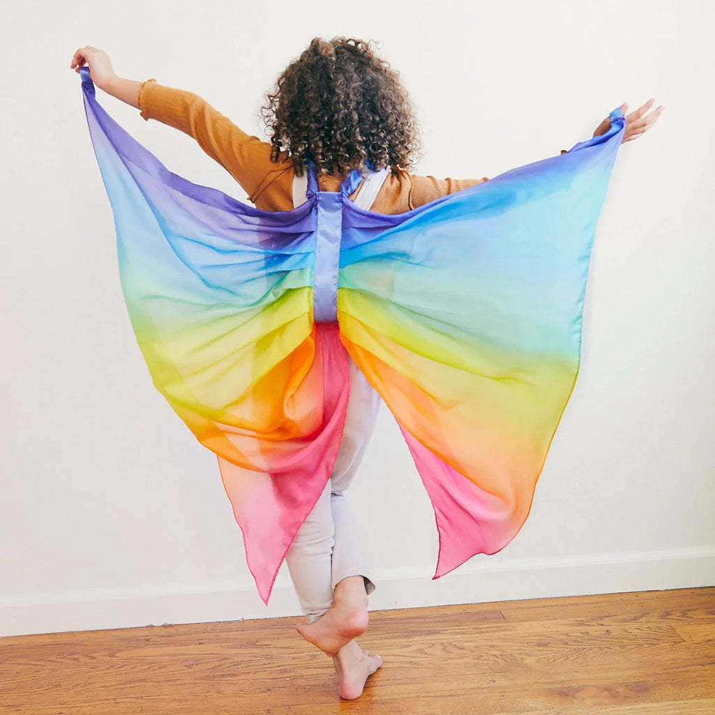 Sarah's Silks Rainbow Fairy Wings Children's Dress-Up Accessory. Modeled on child engaging in active play.