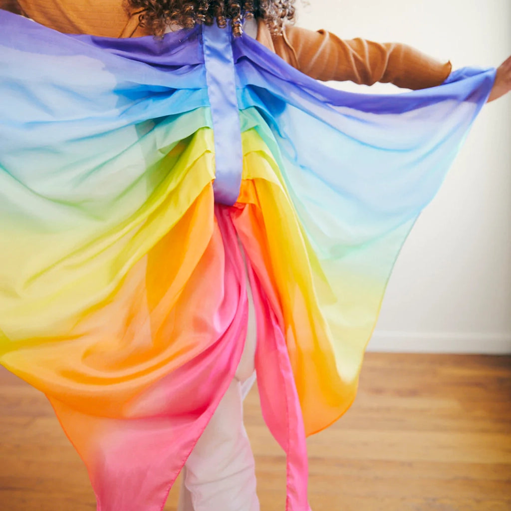 Sarah's Silks Rainbow Fairy Wings Children's Dress-Up Accessory. Modeled on child engaging in active play.