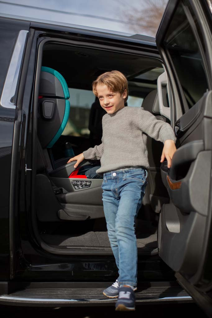 Child with ALTA Teal highback booster seat