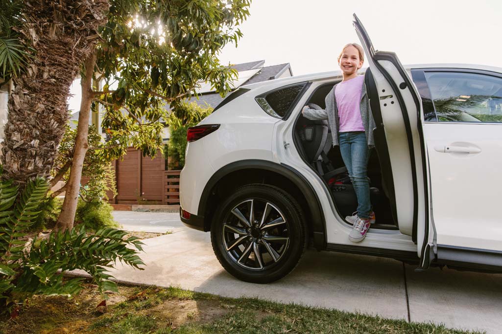 Child leaving car with Alta Booster Seat