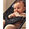 baby playing with hand in anthracite leopard mesh baby bjorn bouncer