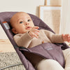 baby laying in purple babybjorn bouncer bliss classic quilt cotton