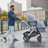 Man pushing Uppababy Bassinet Accessory on Double Stroller