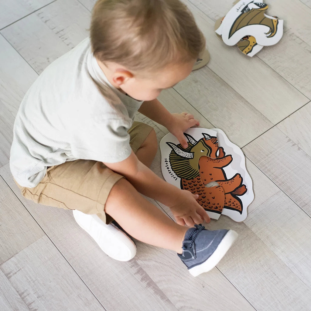 Wee Gallery Dinos Beginner Puzzles Children's Learning Puzzle Set. Lifestyle image of child playing with puzzle.