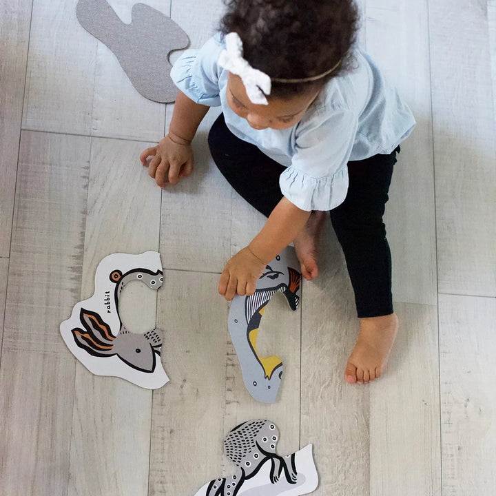 Wee Gallery Pets Beginner Puzzles Children's Learning Puzzle Set. Lifestyle photo of child playing with puzzle sets.
