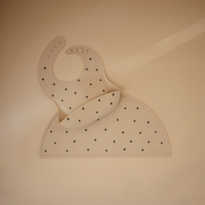 Mushie Silicone Placemats in Black Daisy Elegant daisy prints against a sleek black background for a modern touch