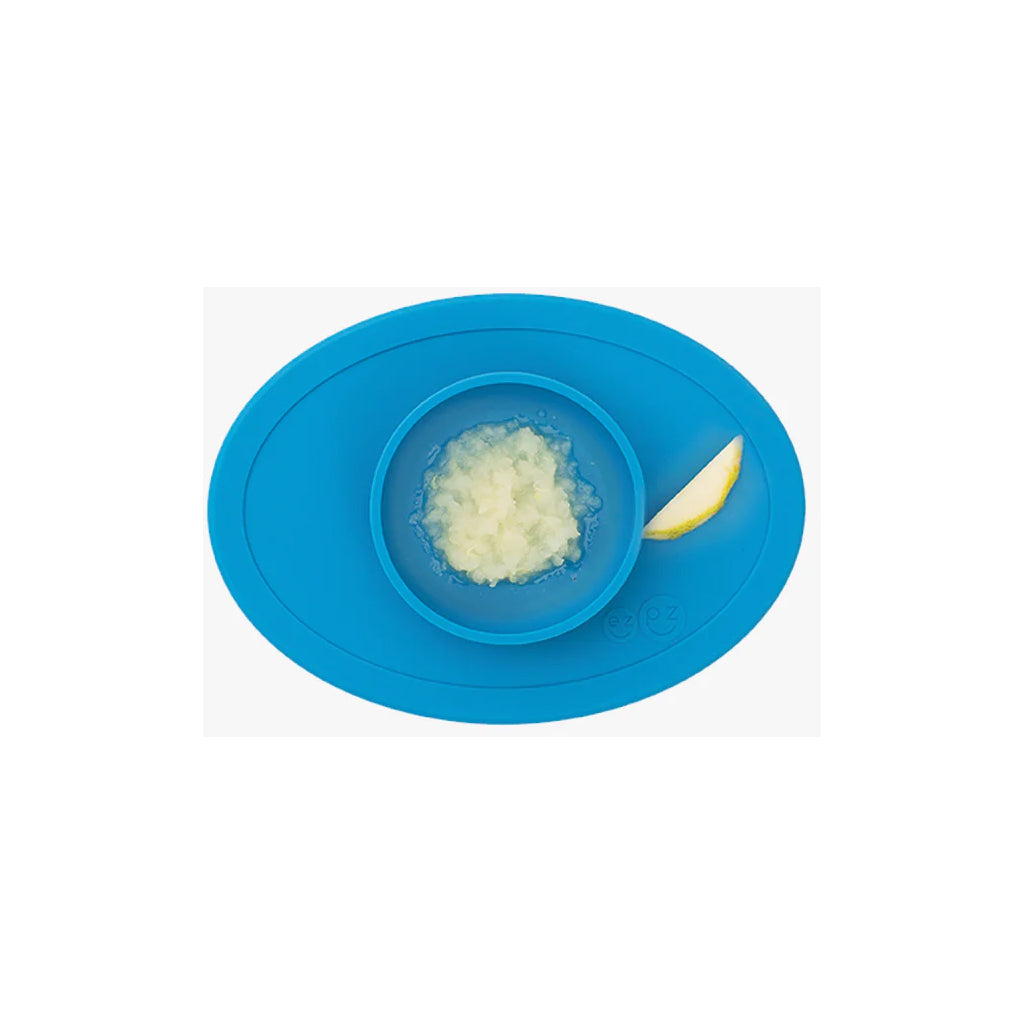 The Blue ezpz baby solid food bowl sticks to tables, preventing messy spills.