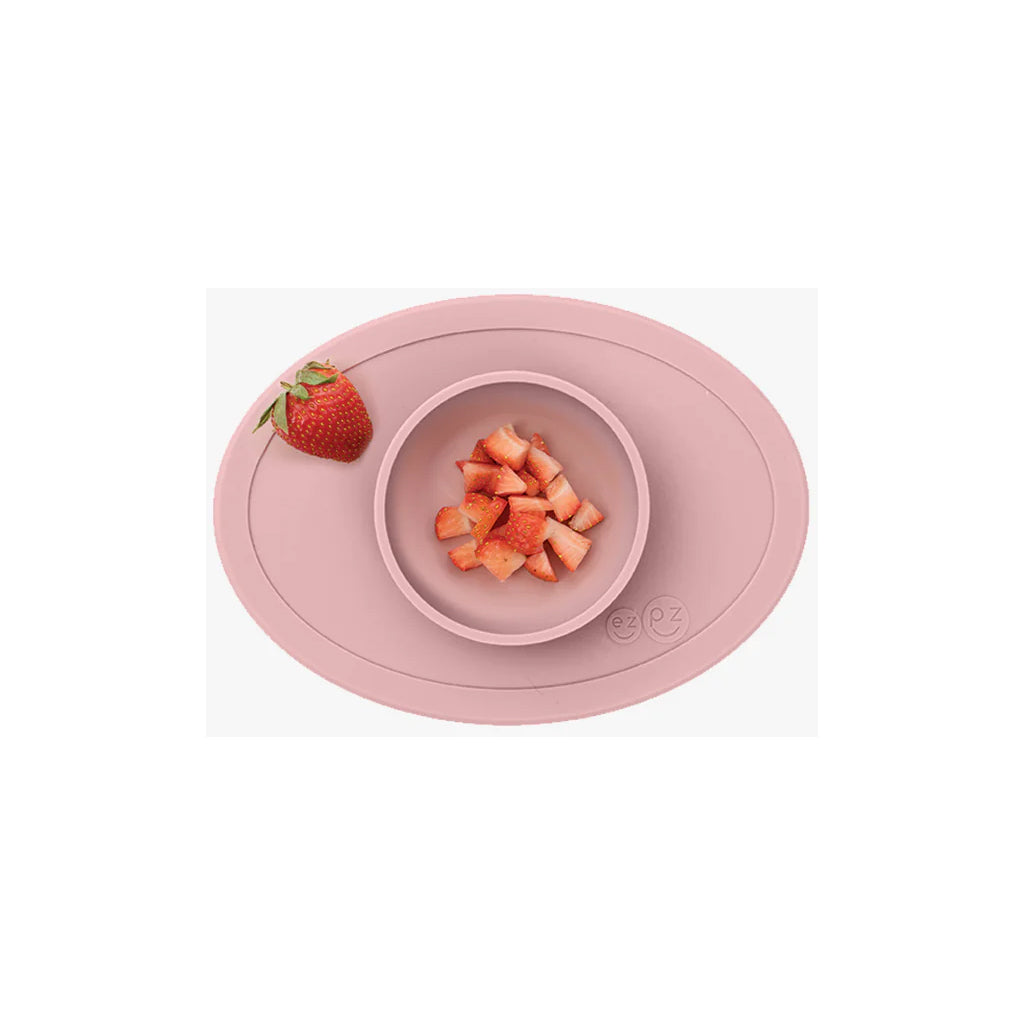 The Blush ezpz baby solid food bowl stays in place with strong suction.