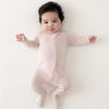 baby wearing kyte baby newborn pajamas in blush pink
