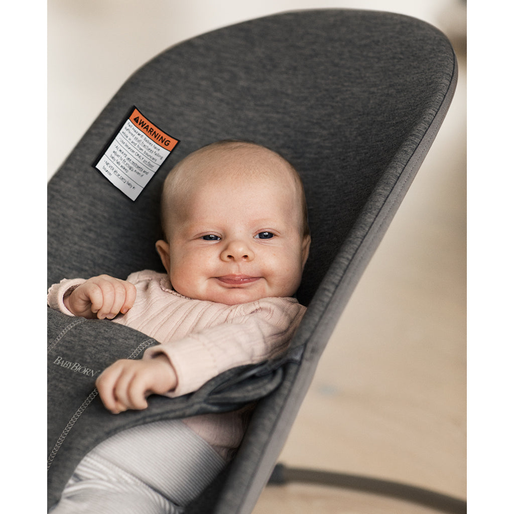 smiling baby in Babybjorn charcoal jersey bouncer seat 
