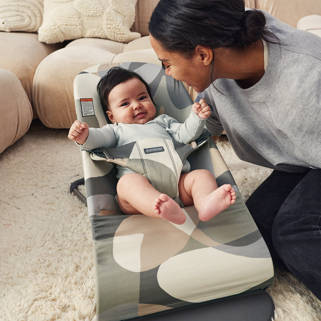 mom laughing with baby in babybjorn bouncer bliss in khaki green cotton