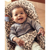 smiling infant in cotton leopard print bouncer bliss by Baby Bjorn