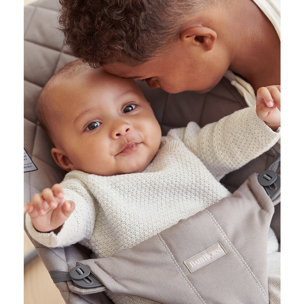 brother inward facing with baby in babyBjorn sand grey bouncer seat