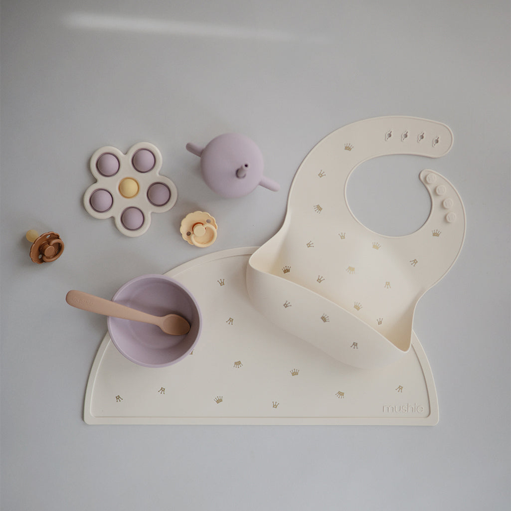 Mushie Placemat Crown Set A set of playful crownthemed placemats for an imaginative mealtime atmosphere