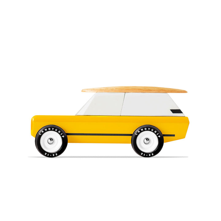 Gold Cotswold Car toy by Candylab, complete with a surfboard on top.