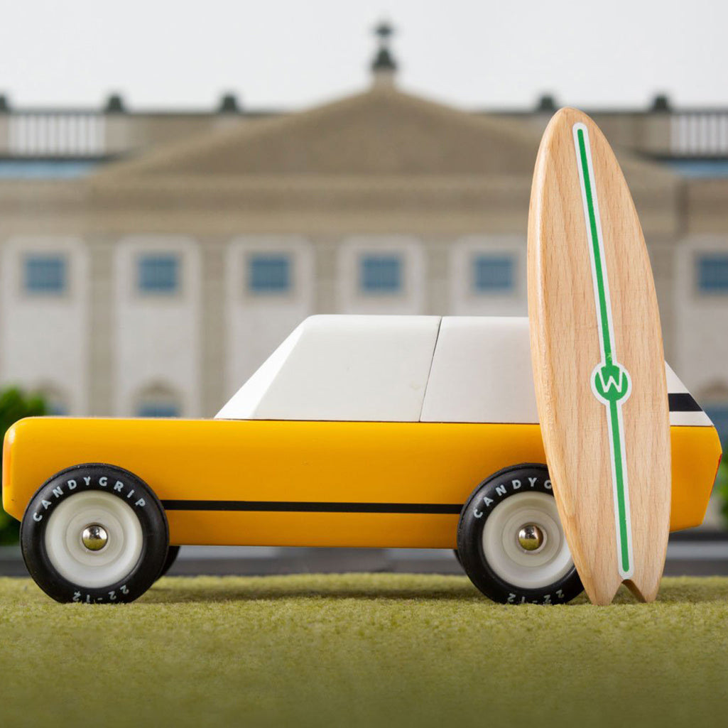 Candylab's gold Cotswold Car, highlighting its sleek surfboard attachment.