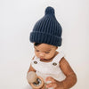 Huggalugs Indigo Peak Knit Beanie Infant to Child Winter Hat modeled on infant.