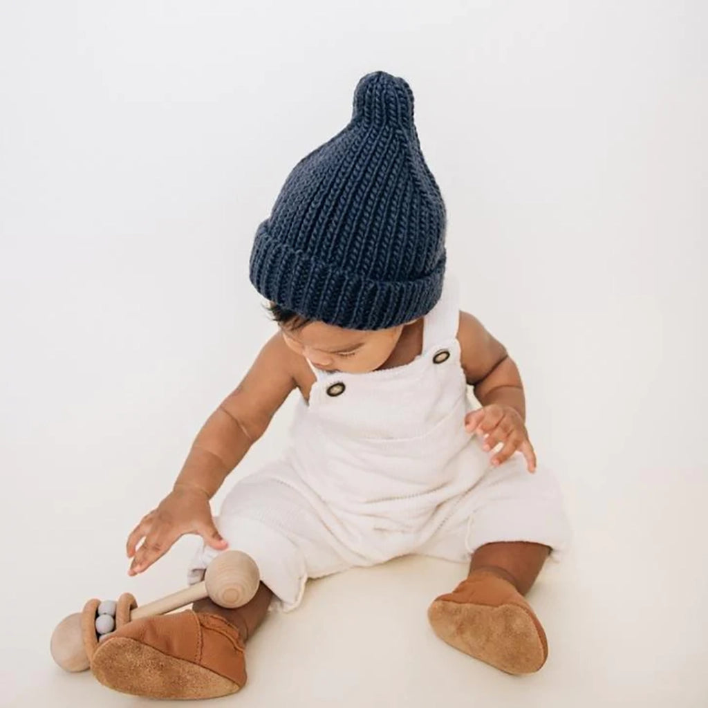 Huggalugs Indigo Peak Knit Beanie Infant to Child Winter Hat modeled on infant.