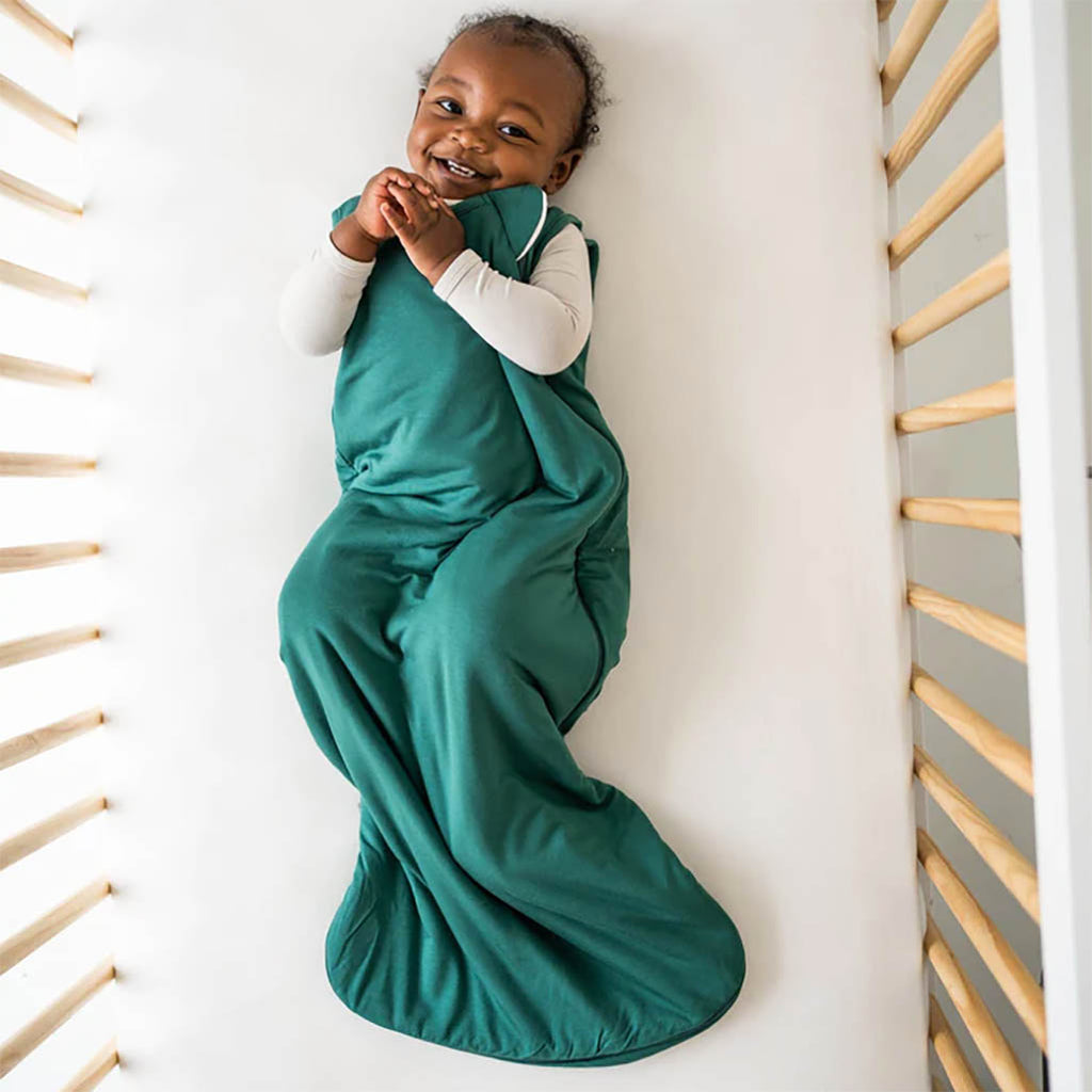Baby wearing KyteBaby Sleep Sack in Emerald