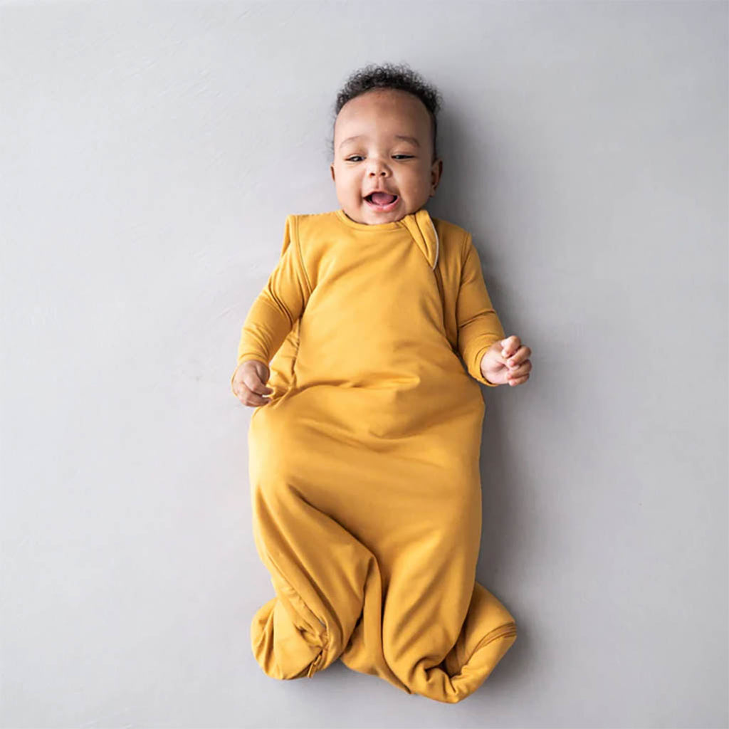 Baby wearing Kyte Sleep Sack in Marigold yellow
