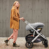 Woman Pushing Vista Stroller with MESA Car Seat and Cozyganoosh