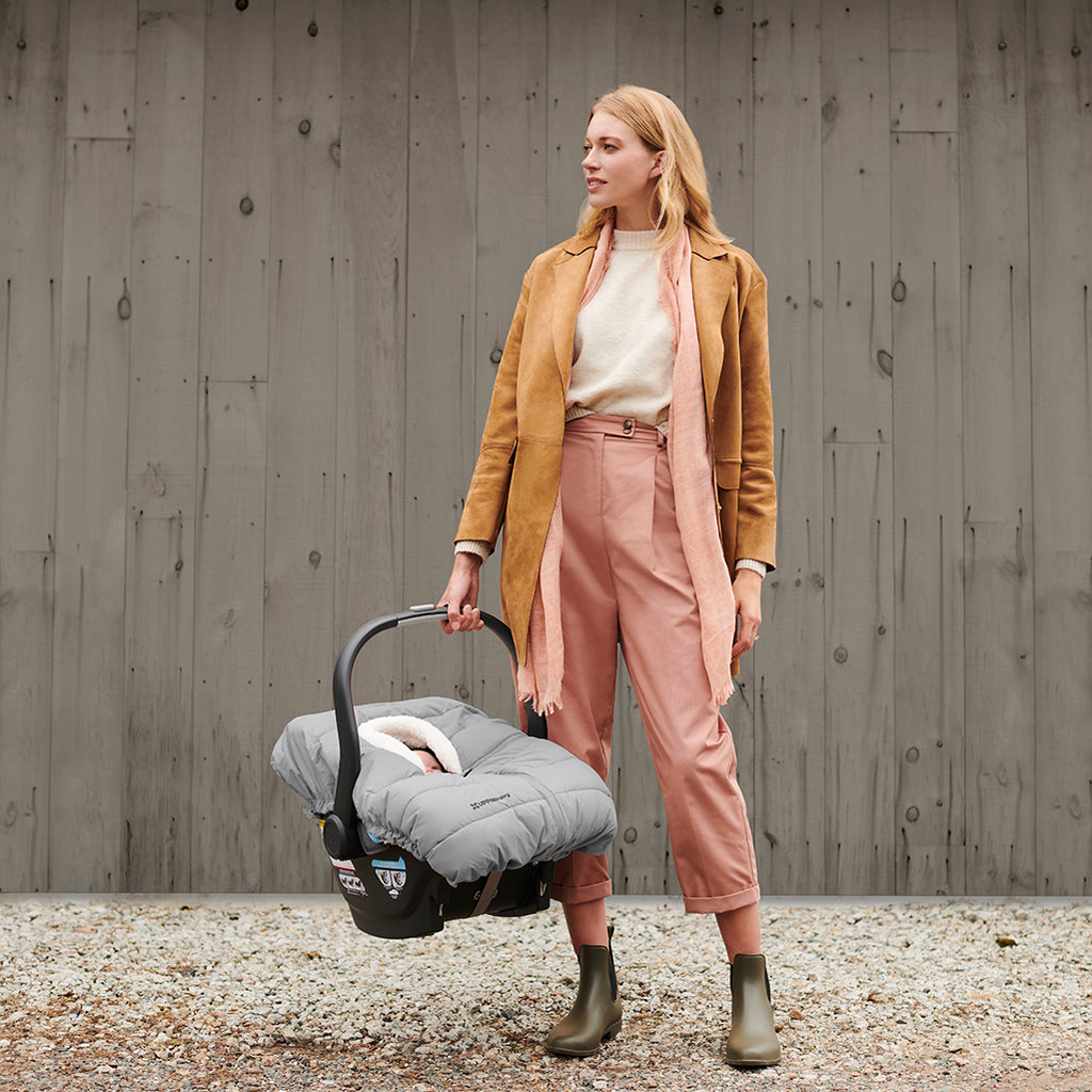 Woman Carrying MESA Car Seat with CozyGanoosh in Stella Grey