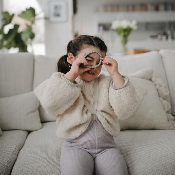 Mushie baby teether bracelets in modern neutral colors perfect for soothing sore gums