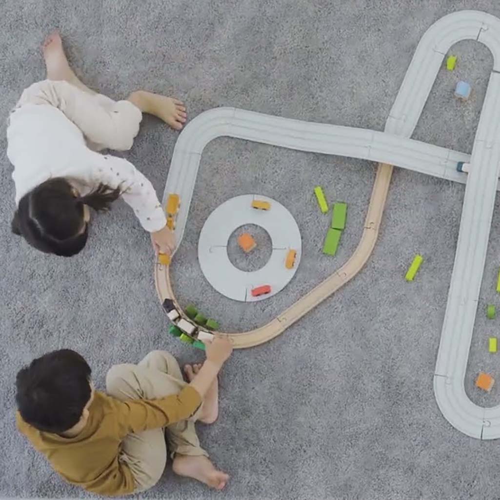 Plan Toys adaptors used to connect wooden and rubber road toy sets, making it easy for kids to build their dream road system.