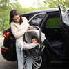 Woman carrying Uppababy Infant Car Seat Mesa in Stella