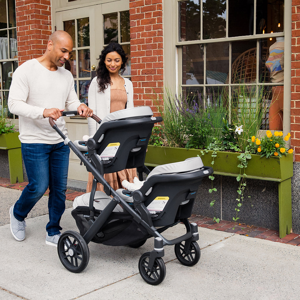 Couple walking with Uppababy Double Stroller