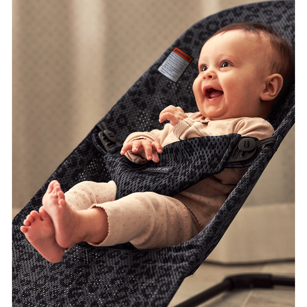 laughing infant in mesh anthracite leopard bouncer bliss from Baby Bjorn