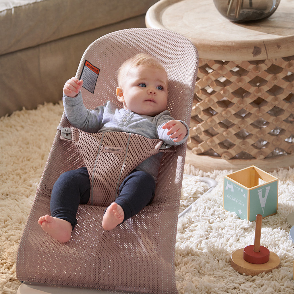 infant laying in mesh dusty pink bouncer bliss from Baby Bjorn