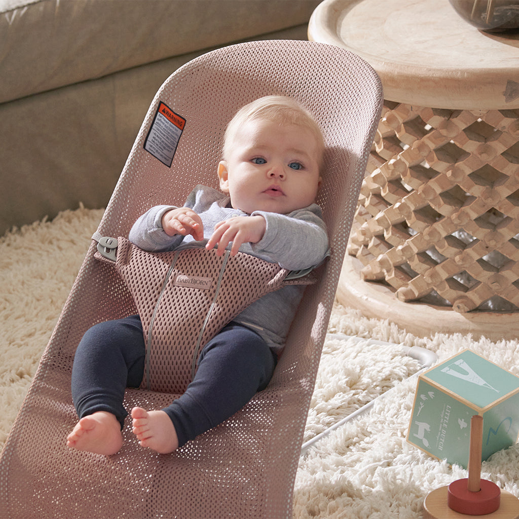 baby in living area in dusty pink mesh baby bjorn bouncer bliss