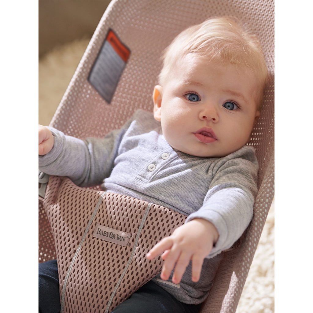 close up of infant in BabyBjorn pink mesh bouncer seat