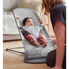 mom facing inward towards baby in babybjorn grey mesh infant bouncer