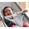 laughing infant in grey mesh babybjorn baby bouncer
