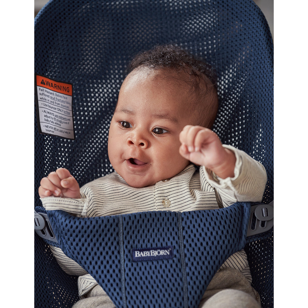 excited baby in navy blue mesh bouncer bliss by BabyBjorn