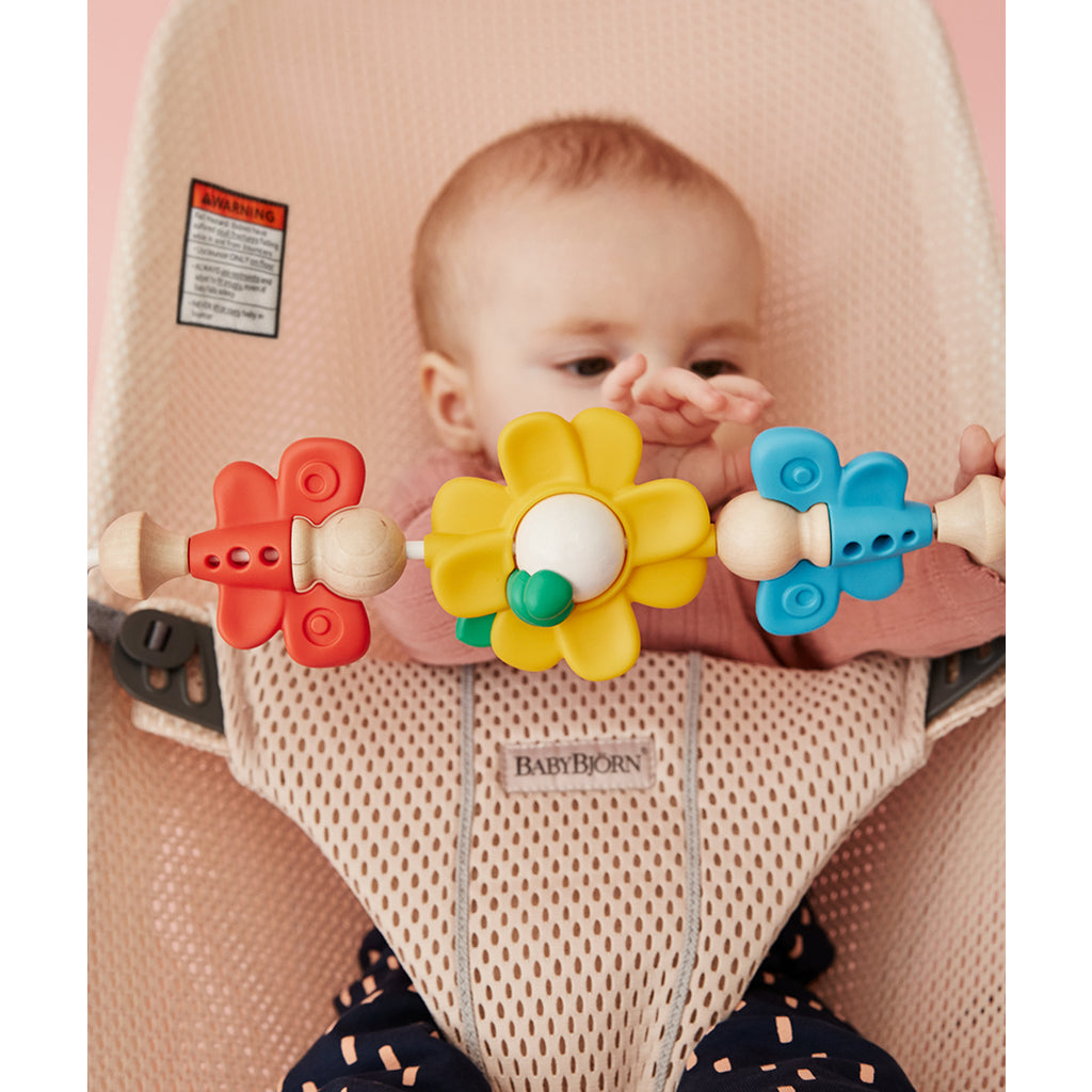baby playing with babybjorn bouncer toy in baby Bjorn bouncer pearly pink
