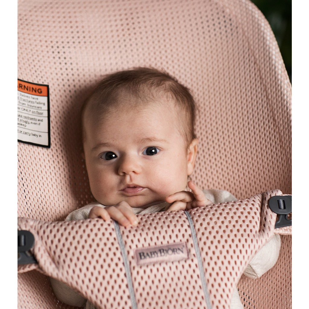 infant looking forward in bjorn bouncer bliss pearly pink mesh