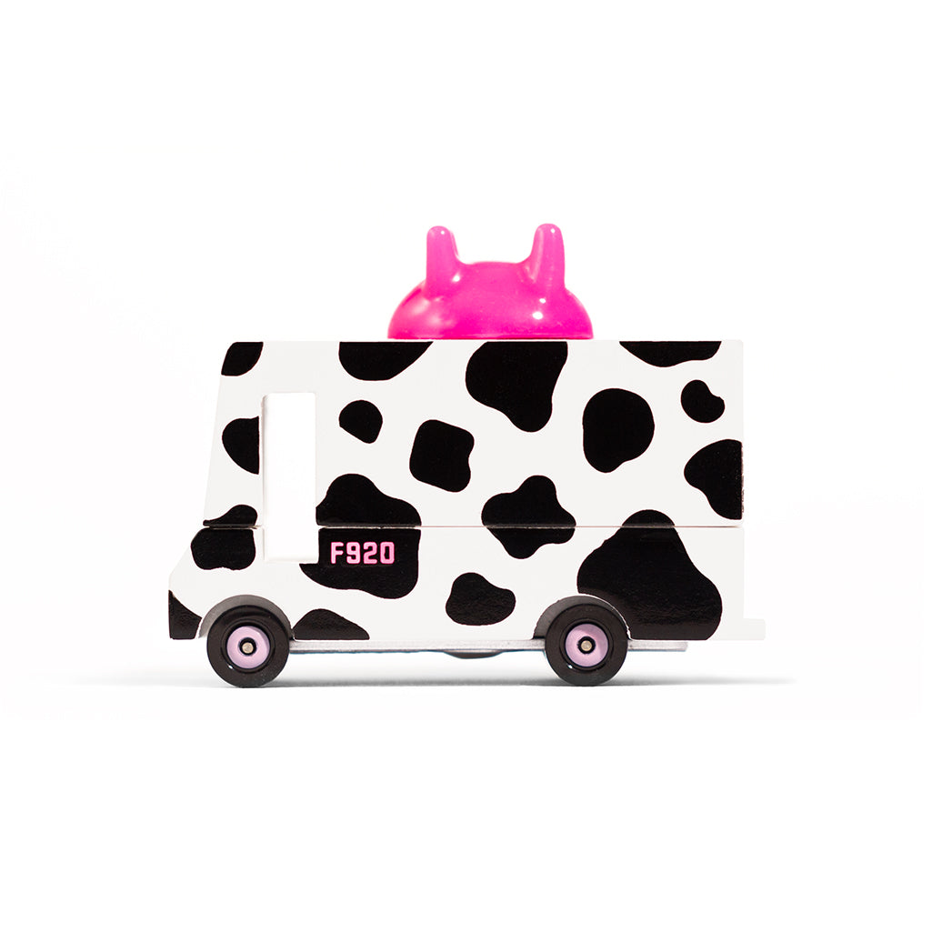 Candylab cow-print milk van, a unique wooden food truck toy for children.