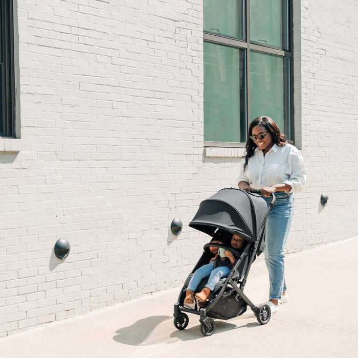 Woman and Toddler walking with Uppabay Stroller Minu V2 in Greyson